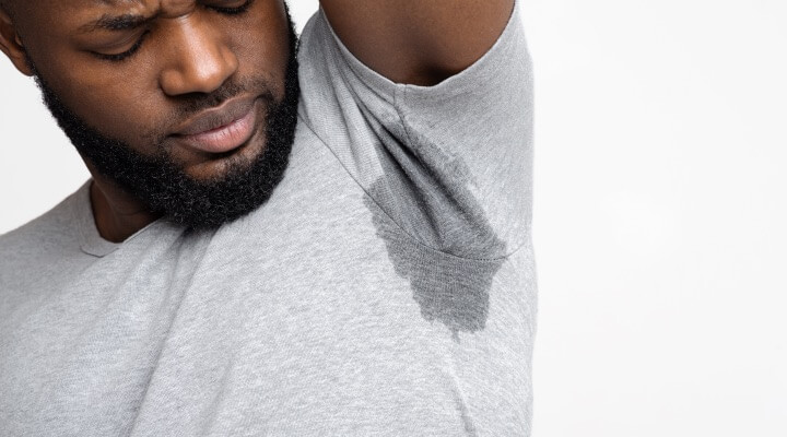man sweating through shirt