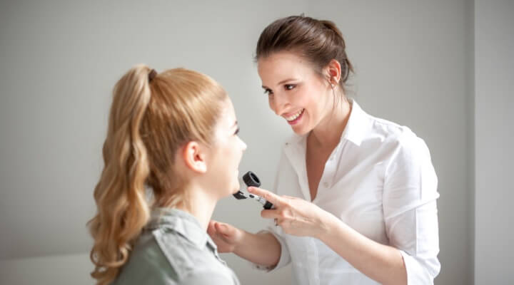 dermatologist inspecting teenager