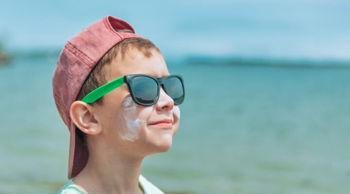young boy with sunscreen on face