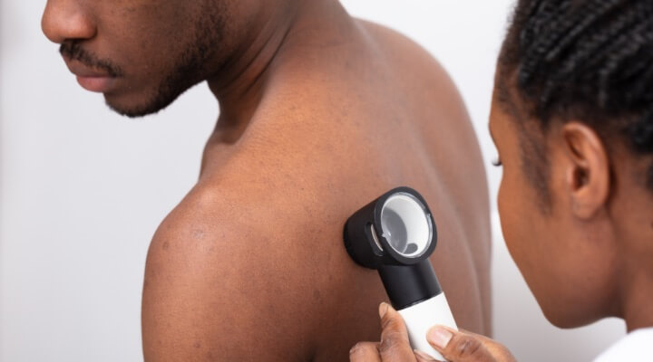 Man having skin examined