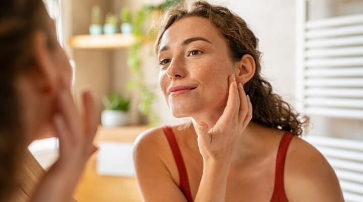 woman examing face