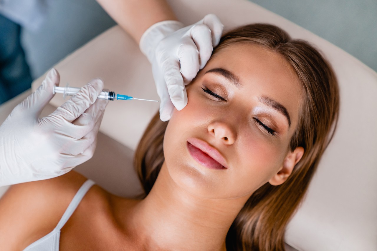 Woman receives botox injections in her face.
