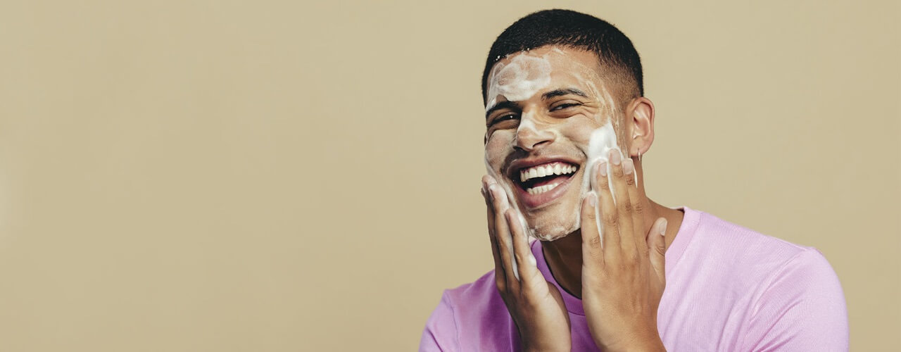 man washing face