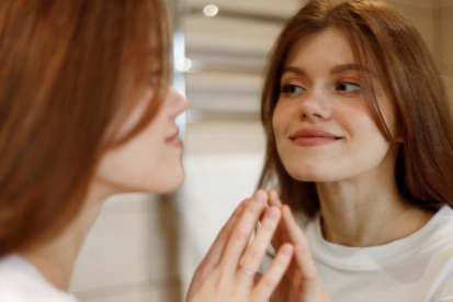 smiling-woman-looking-at-mirror